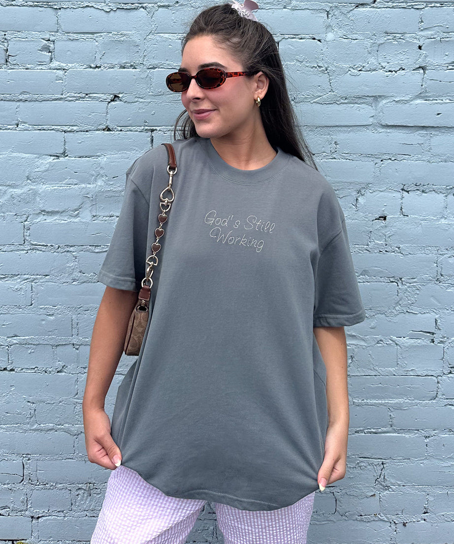 God's Still Working Unisex Tee